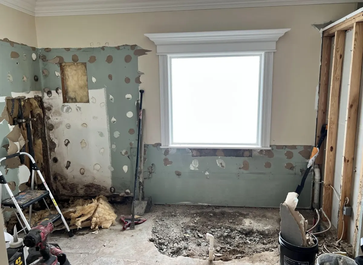 Water-damaged bathroom gutted to studs