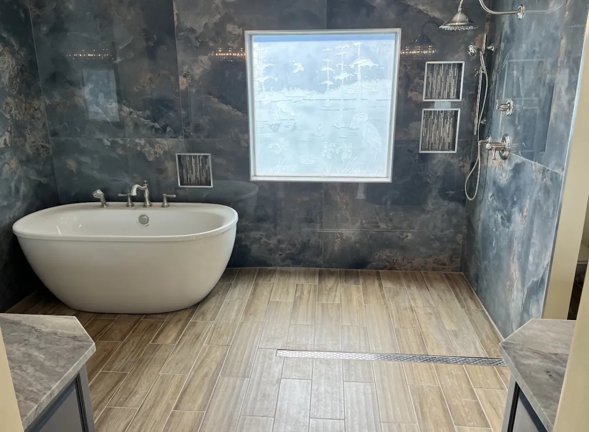 Dark marble bathroom with freestanding tub
